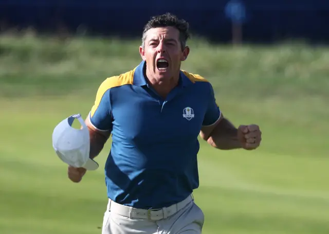 Europe's Rory McIlroy pumps his fist and roars in celebration after winning his Ryder Cup singles match