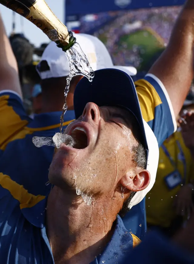 Rory McIlroy drinks champagne after Europe won the Ryder Cup