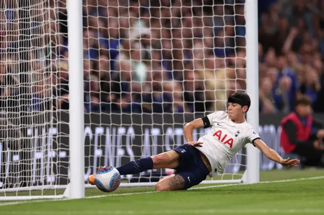 Neville slides in vain to prevent the ball going over the line.