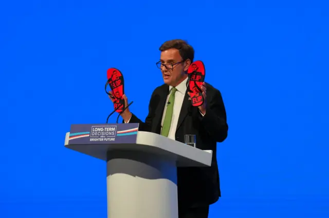 Greg Hands holding Keir Starmer flip flops