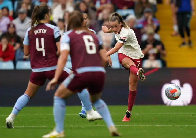 Toone takes aim at goal through some Villa defenders.