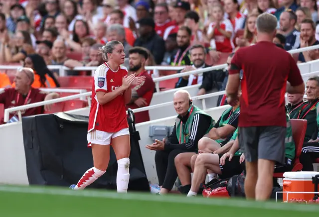 Russo makes way her way to the bench after being taken off.