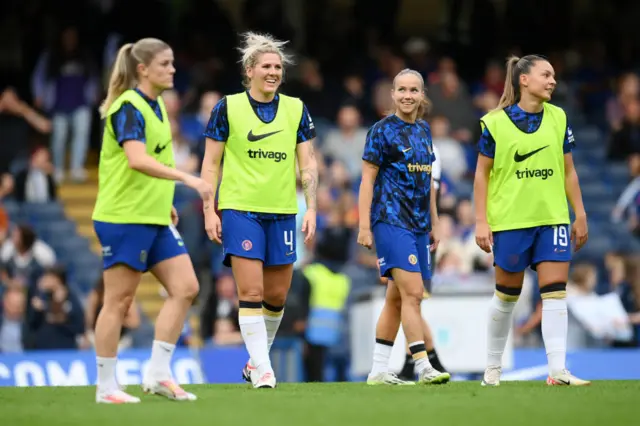 Chelsea players warm up at Stamford Bridge.