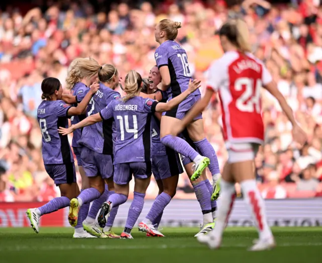 Liverpool celebrates as Lacasse trudges back to the half way line for kick off.