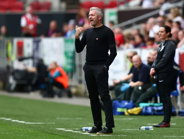 Leicester boss Willie Kirk looks on from the sidelines.