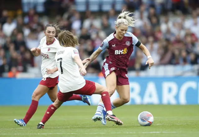 Daly tries to dribble past Toone as Zelem watches on.