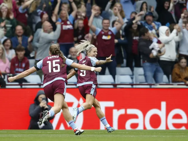 Daly celebrates with teammates after oepning the scoring.