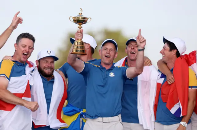 Europe captain Luke Donald lifts aloft the Ryder Cup alongside his celebrating players