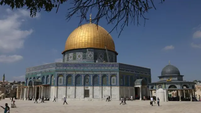 Palestinians walk past the Dome of the Rock at the al-Aqsa Mosque compound in Jerusalem, Israel - 6 October 2023