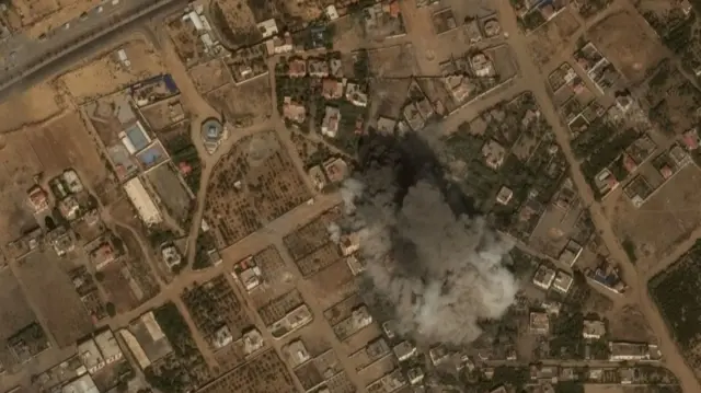 Satellite imagery of Gaza, collected on Tuesday, shows a plume of smoke following an airstrike