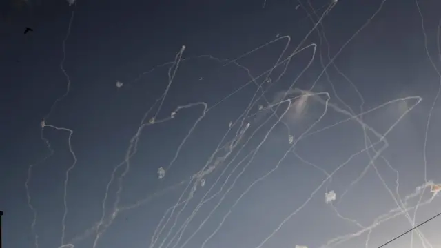Intercepted missiles float in the sky