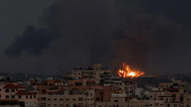 An explosion in the distance in Gaza City, October 10, 2023