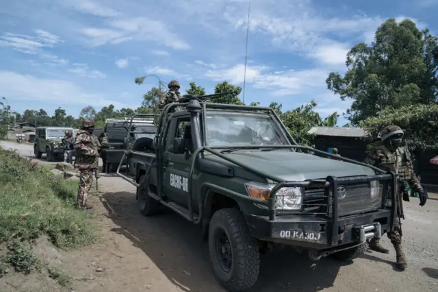 Soldiers from the East African Community Regional Force (EACRF) accompany journalists into areas under the control of March 23 Movement (M23) in Bunagana, Democratic Republic of Congo, on April 19, 2023