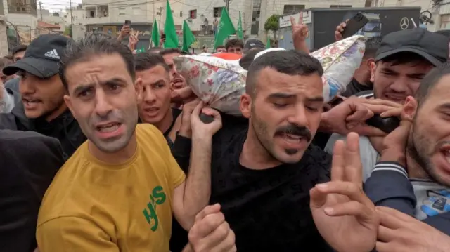 Mourners in Hebron carry the body of a Palestinian killed by Israeli troops in the West Bank