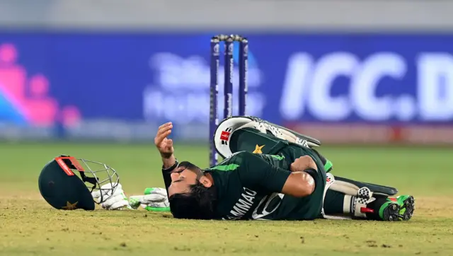 Pakistan's Muhammad Rizwan goes down holding his back