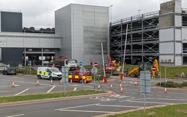 Workmen and construction vehicles were spotted digging up land next the car park for the new road.