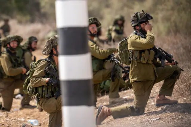 IDF soldiers guarding a road near Kibbutz Kfar Aza where dozens of civilians were killed