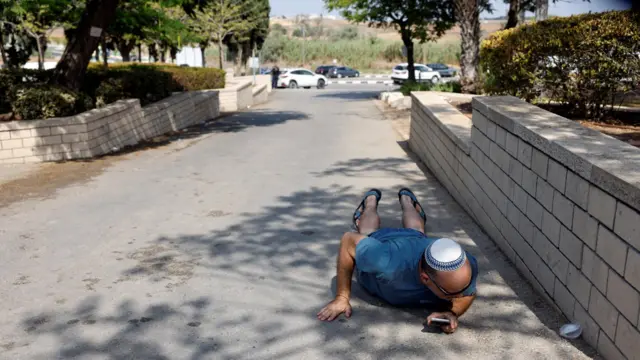 Man lying on ground in Ashkelon, 10 Oct