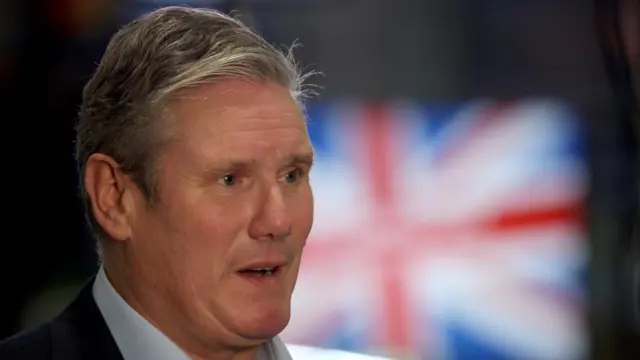 Labour leader Sir Keir Starmer stands in front of a union jack flag