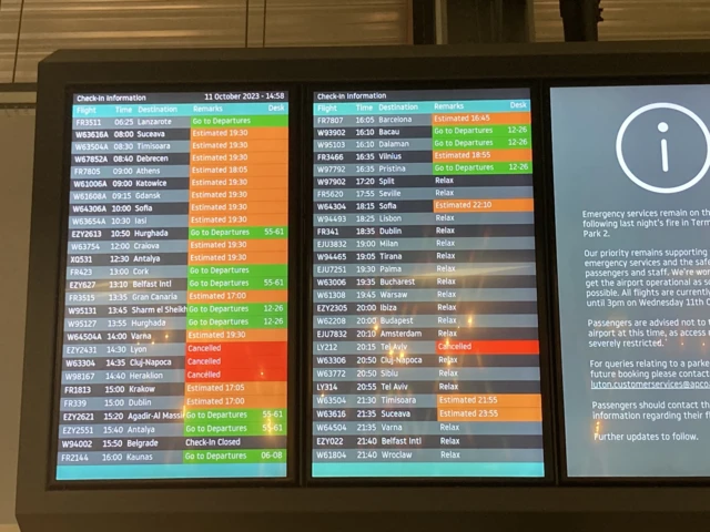 Picture of Luton departure board, showing some flights listed as "go to departures"