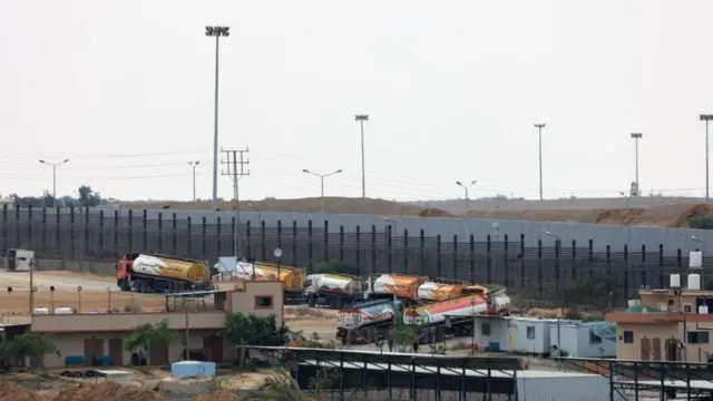 Getty says this image shows trucks leaving Rafah border crossing with Egypt during an Israeli airstrike on 10 October 2023