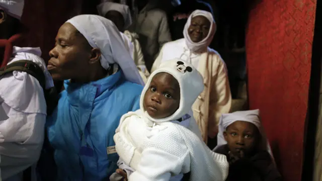 Nigerian pilgrims inside the Grotto at the Church of the Nativity, believed to be the birthplace of Jesus Christ, on December 24, 2014 in the West Bank biblical town of Bethlehem.