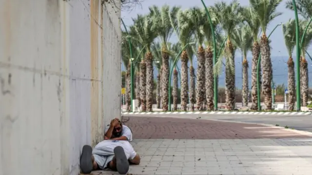 People take cover in the Israeli city of Ashkelon on 11 October