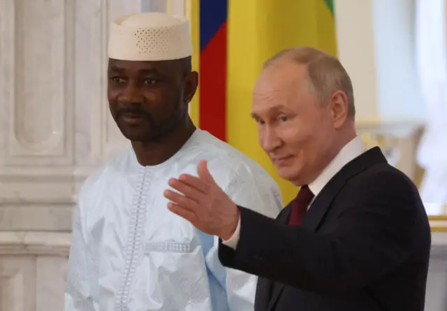 Russian President Vladimir Putin (R) greets President of Mali Assimi Goita (L) during their bilateral meeting, on July 29, 2023 in Saint Petersburg, Russia.