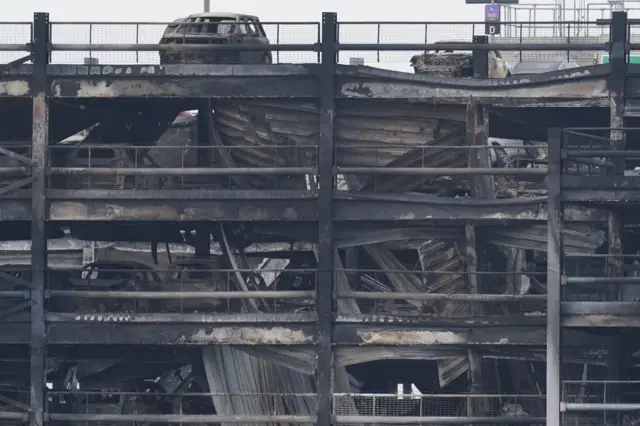 Damage shows how floors have collapsed on top of each other and cars