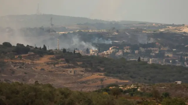 Smoke rises from Dhayra village as pictured from the Lebanese town of Marwahin, southern Lebanon, October 11, 2023