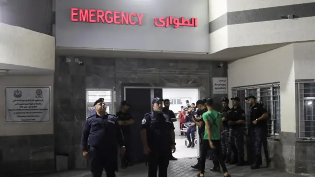 Palestinian policemen stand guard outside the emergency department, inside Shifa Hospital, in Gaza