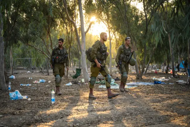 Israeli soldiers searching the Supernova Music Festival site