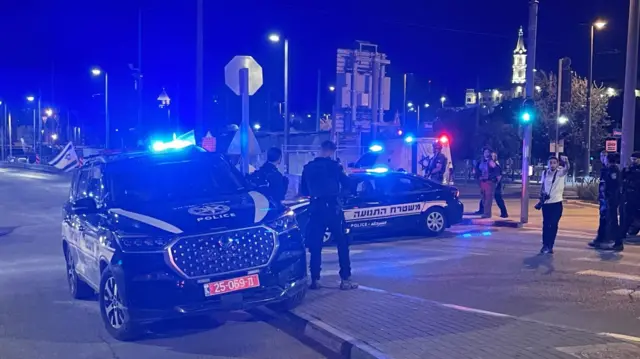 Police cars in street after shooting in Jerusalem