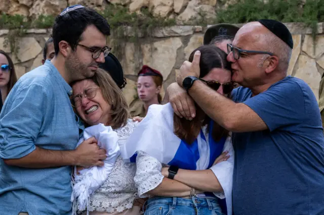 Mother and sister of Valentin Ghnassia crying at his funeral