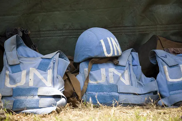 UN blue helmets and flak jackets.