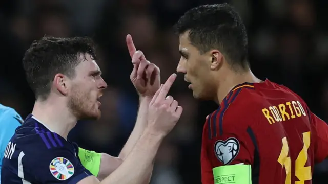 Scotland's Andy Robertson clashes with Spain's Rodri