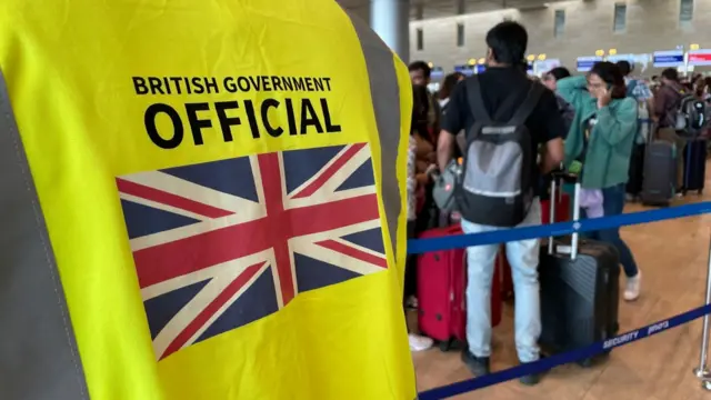 The back of a hi-vis vest showing a British flag and the words "British government official"