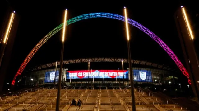 Welbley arch lit up in rainbow colours