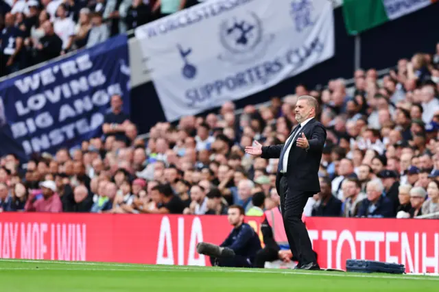 Ange Postecoglou and a banner supporting him at Tottenham Hotspur Stadium