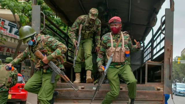 Police officers from the General Service Unit (GSU) disembark their truck while carrying batons and teargas cannisters before they embark on dispersing protestors taking part in a march to protest against police brutality and harassment, especially against the poor, in Nairobi on July 7, 2020.