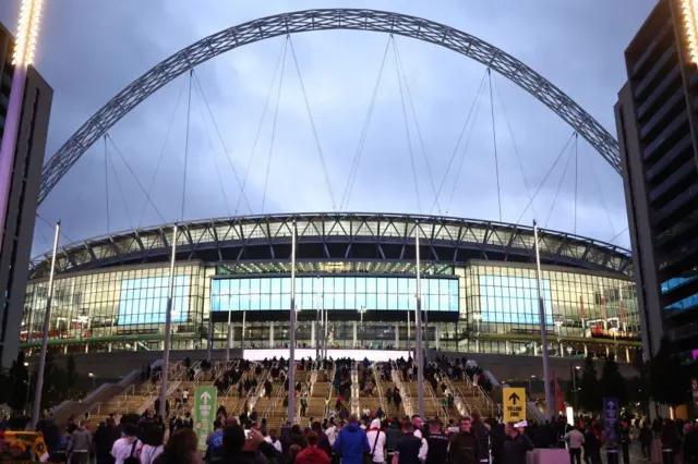 Fans walking towards Wembley Stadium