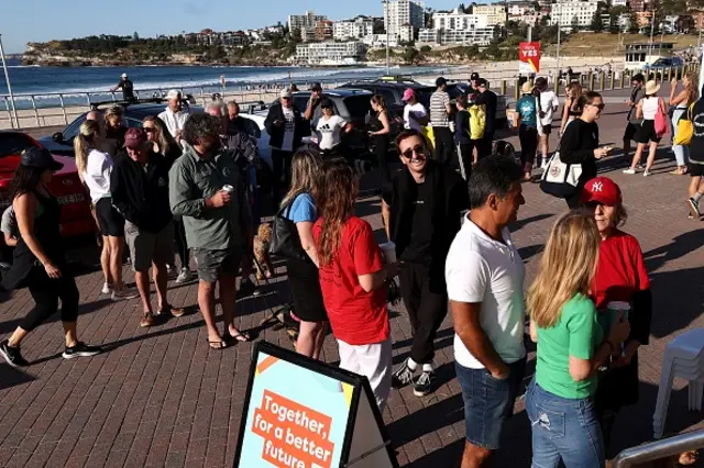 Voters queue up outside a polling station on Bondi Beach in Sydney