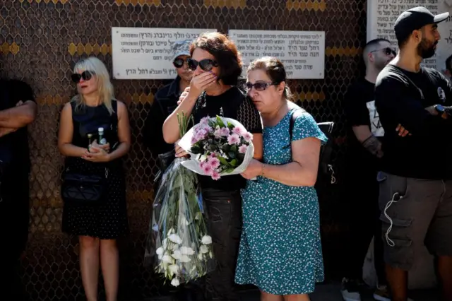 Women mourn Daniella Dana Petrenko, from Haifa, who was killed in a deadly attack by Hamas gunmen at Supernova festival, which she had attended with her boyfriend