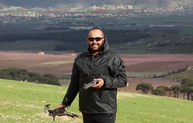 Reuters' journalist Issam Abdallah holds a drone during an assignment in Western Bekaa, Lebanon, March 19, 2023