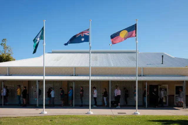 Australians queue to vote at Doubleview Primary School voting center in Perth 14 October 2023.