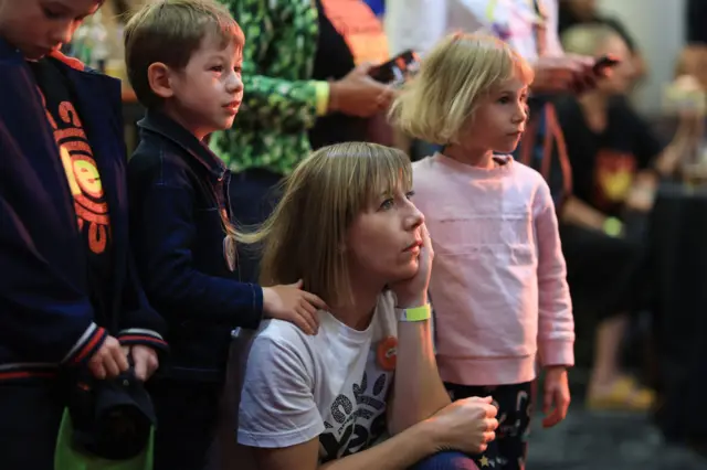 NSW minister Joanna Haylen watches on with her children in Sydney as the votes are tallied