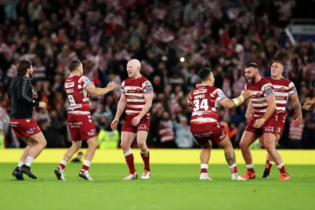 Wigan players celebrate winning the Grand Final