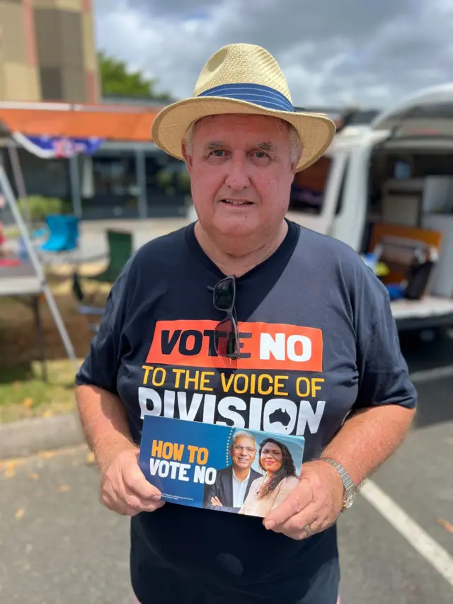 No voter Rob Muller holds campaigning cards