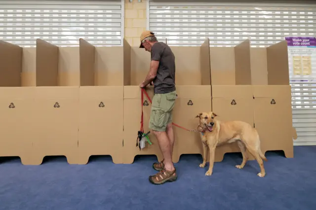 A man casts his vote at Doubleview Primary School voting center in Perth, Australia 14 October 2023.