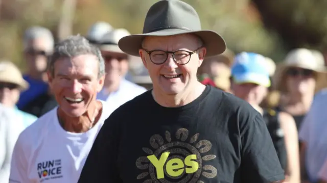 Anthony Albanese wearing a hat and black Yes shirt